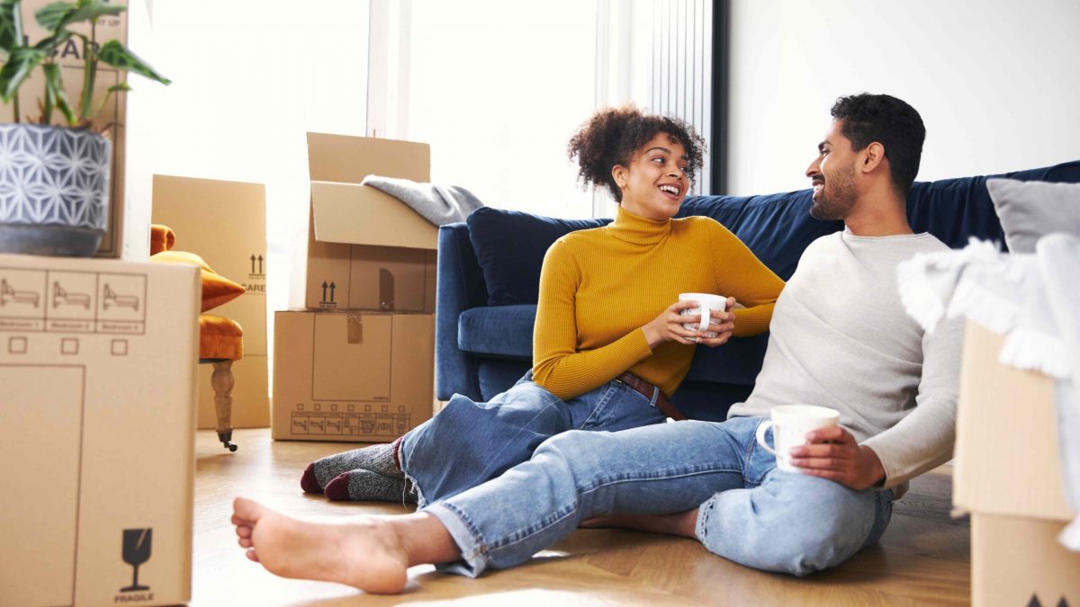 happy couple moving into home