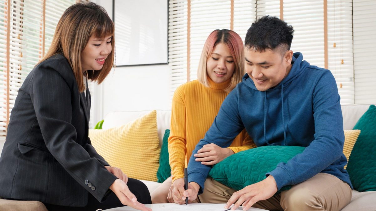 Asian couple sign home contract and handshake with realtor at living room in new home.buying new house real estate