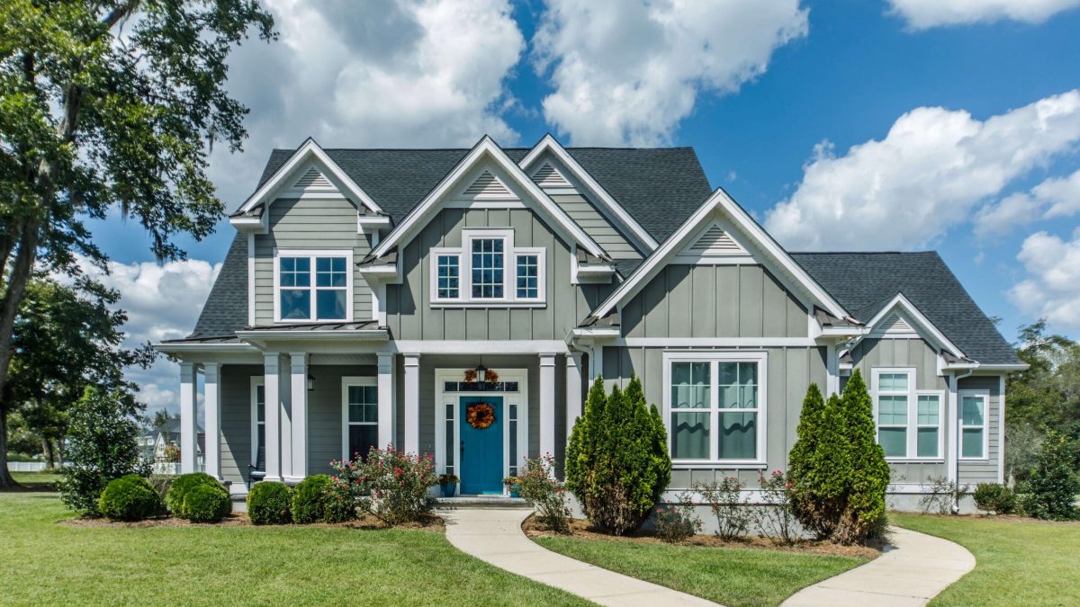 maryland mortgage refinance rates seen in blue house with big clouds behind it.