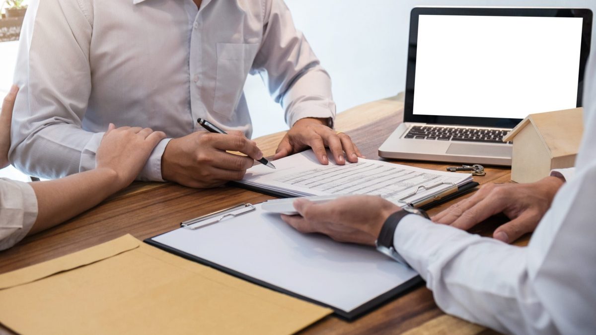 Young couple meeting with a banker for a home loan, Real Estate concept.